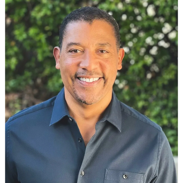 Headshot of David White, Founder and CEO of 3CG Ventures, smiling outdoors in front of green foliage