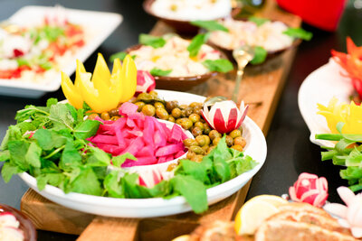 A colorful mezze and appetizer spread on a wooden board