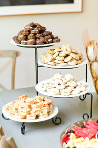A tiered dessert stand with cookies and pastries at a corporate event