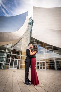 A couple kissing in front of the Walt Disney Concert Hall