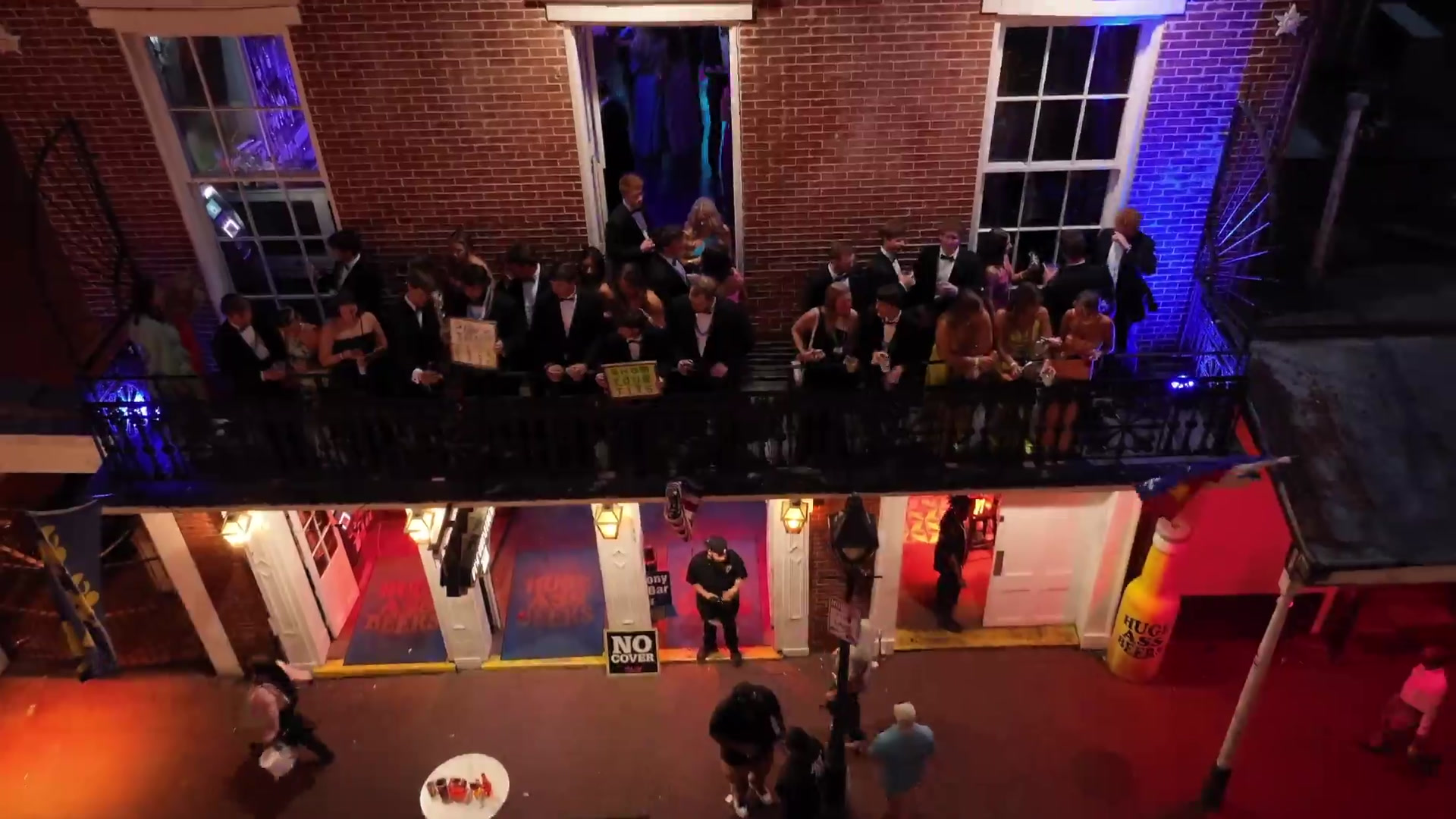 Formal group on a New Orleans French Quarter balcony at night