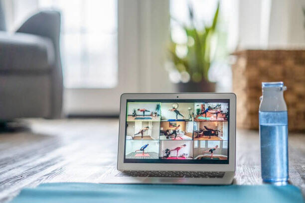 Laptop showing a virtual online fitness class