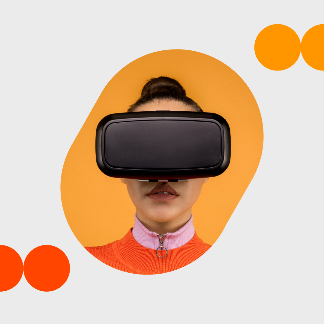 A person in an orange top wearing a virtual-reality headset, surrounded by orange and red circular shapes.