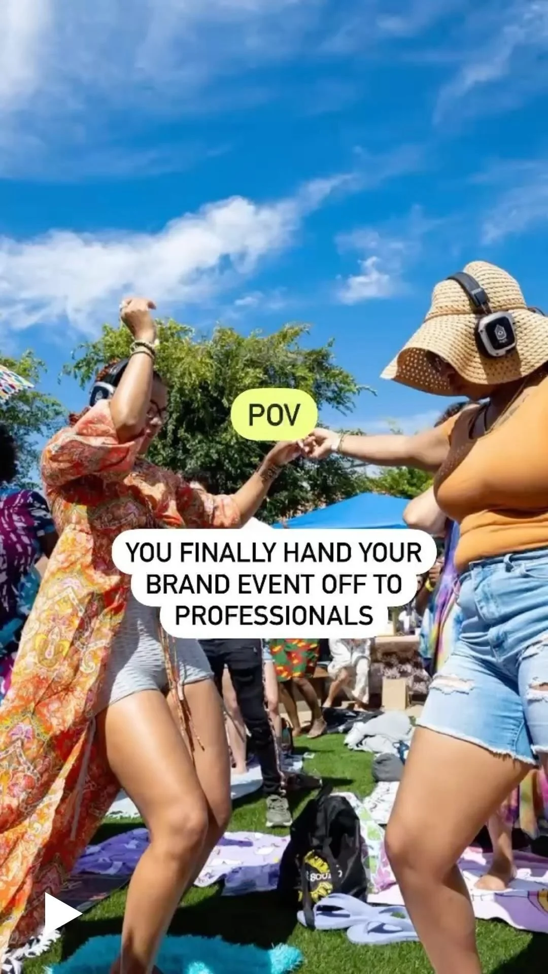 Two women dancing outdoors at a brand event