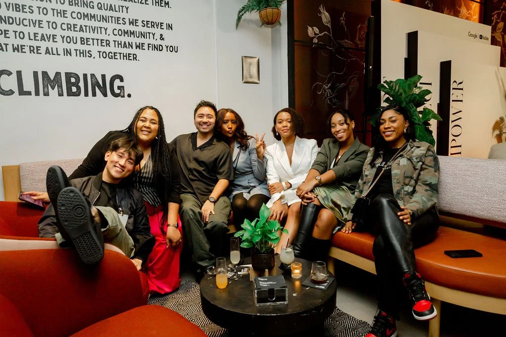Seven guests posing together on a sofa at a Google Social Hour event