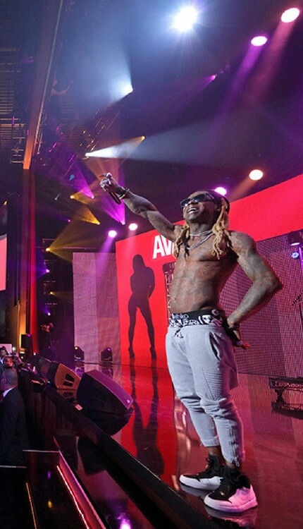 Performer on stage at AVN Awards under dramatic lighting
