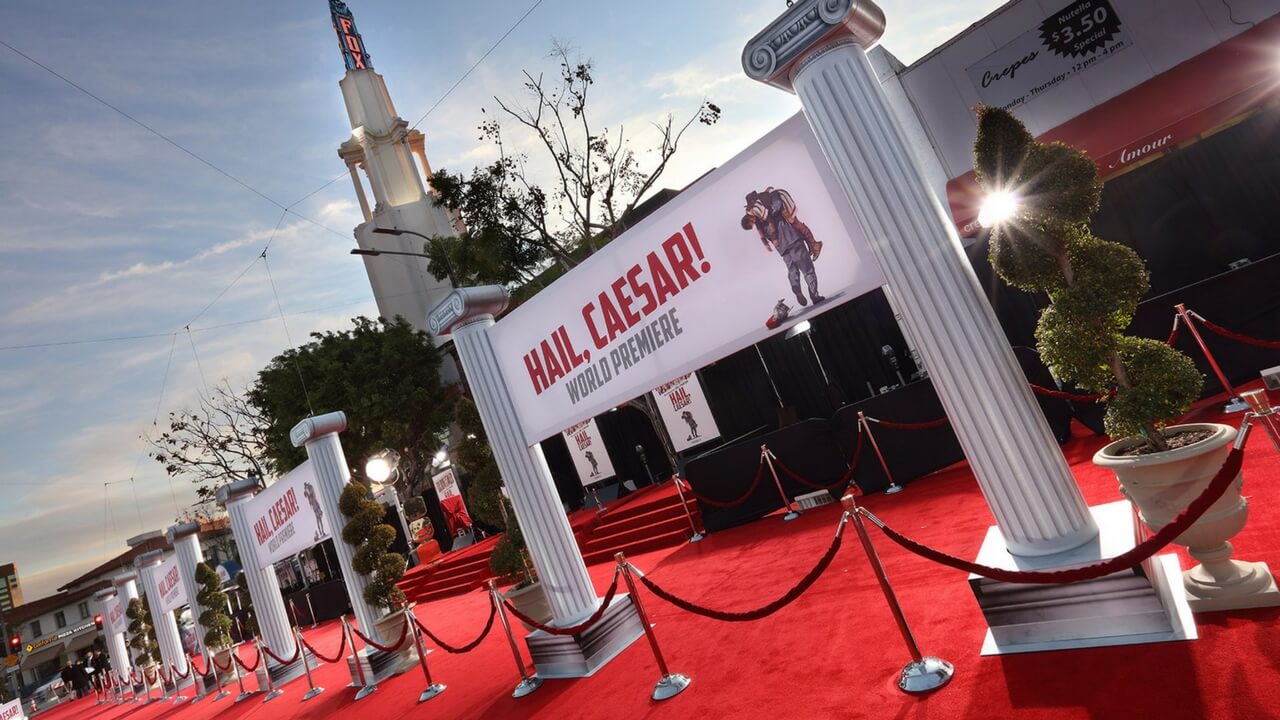 Hail Caesar world premiere red carpet with roman column décor outside Fox Village Theatre