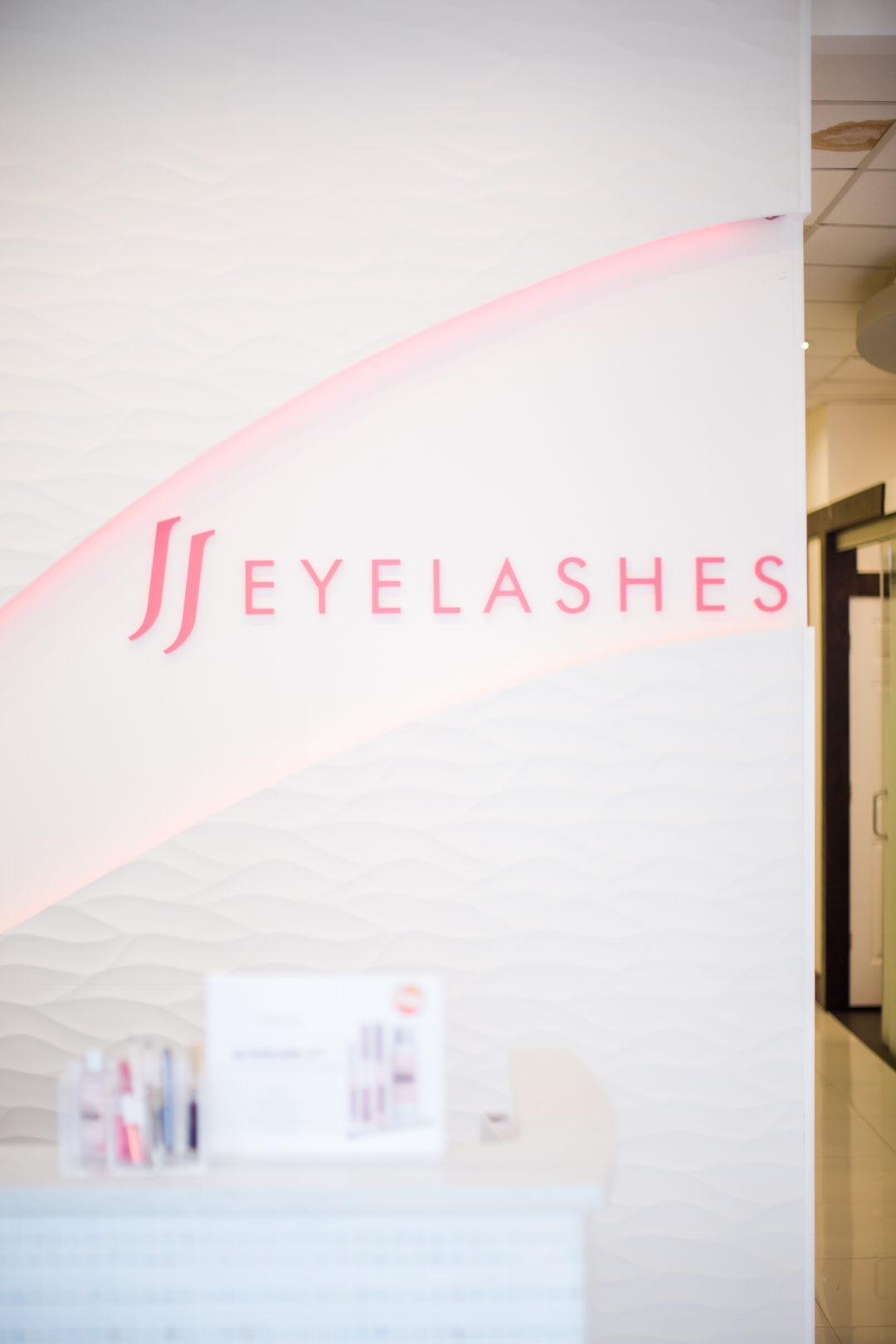 JJ Eyelashes brand sign on the wall