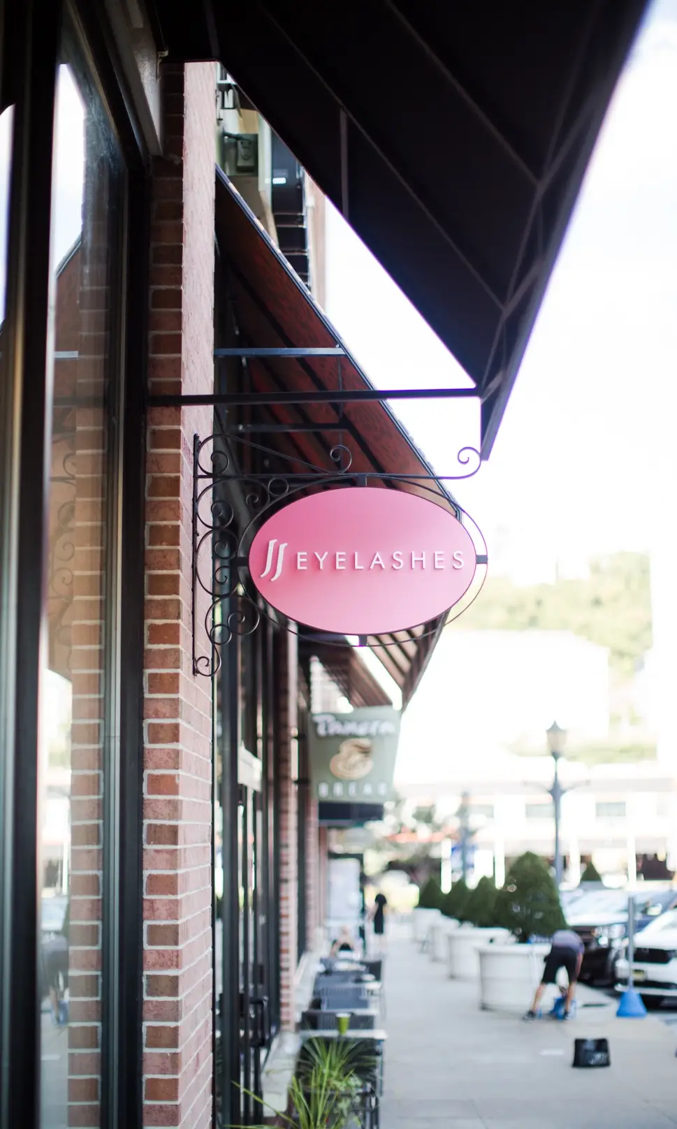 JJ Eyelashes pink oval storefront sign