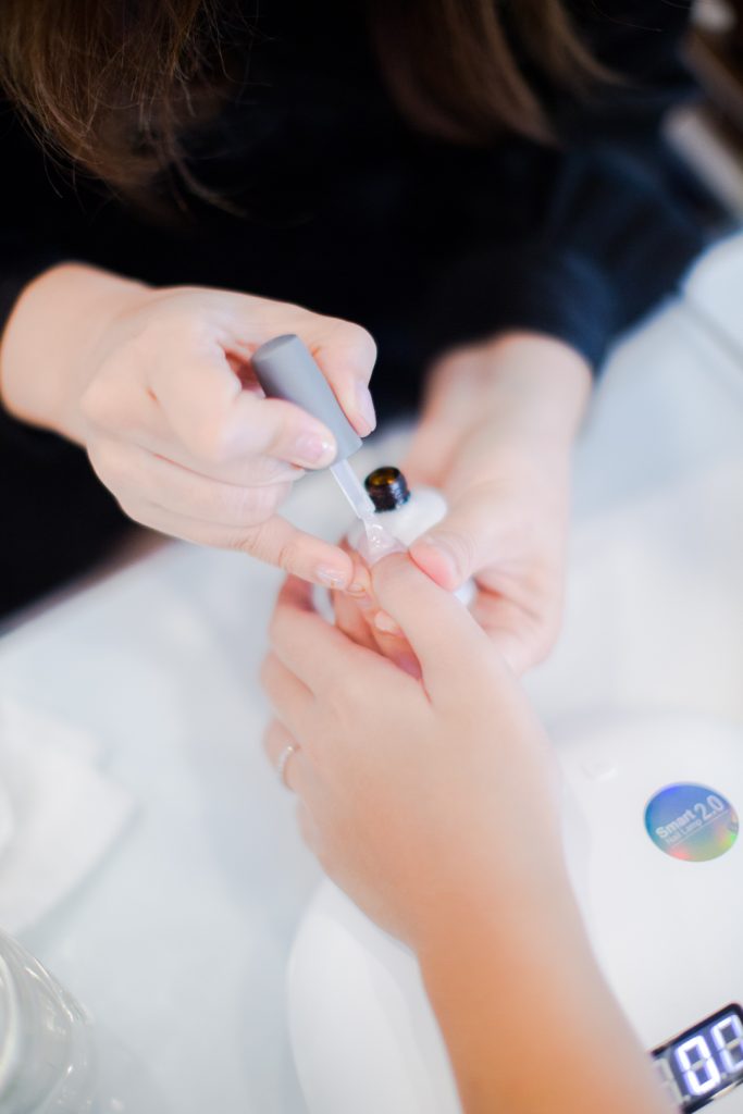 Technician applying treatment to a client's hand
