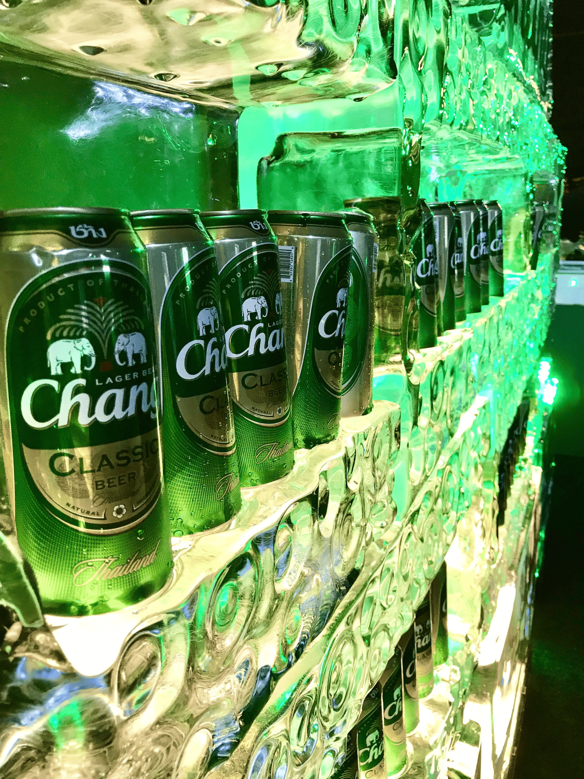 Chang Classic Beer cans in illuminated ice sculpture with green lighting