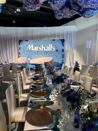 Marshalls branded event with blue floral backdrop