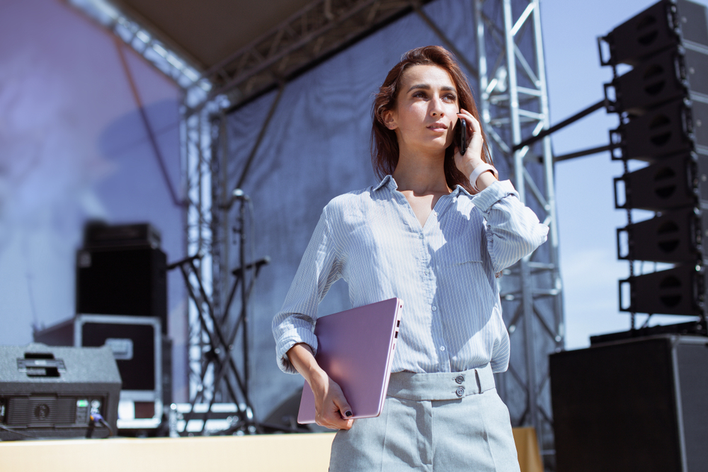 Event producer coordinating an outdoor stage