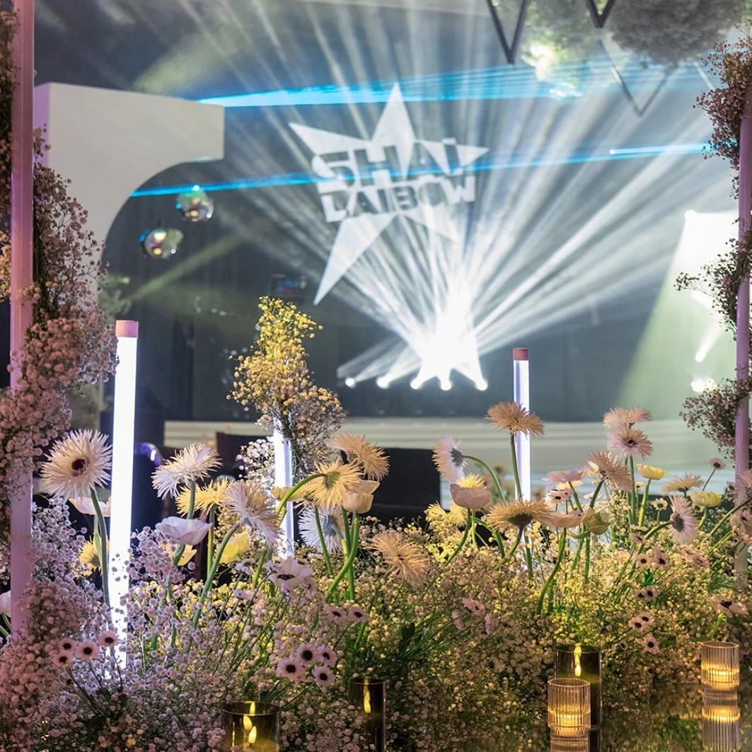 Shai's celebration — floral tunnel entrance and star-logo stage