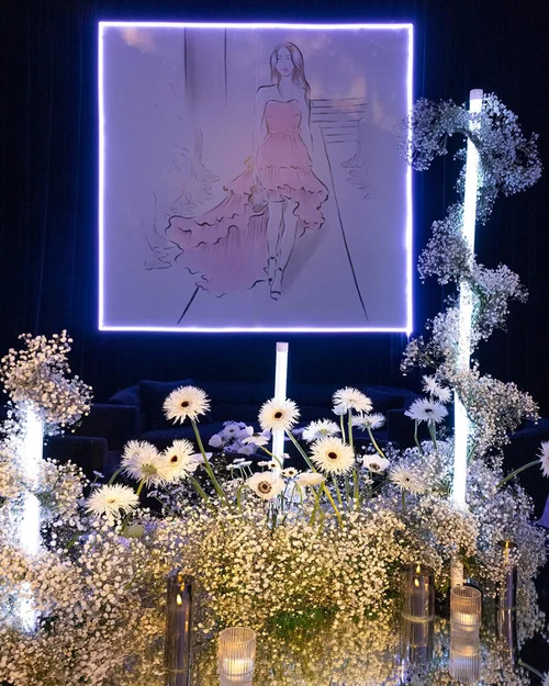 Elegant floral setup with neon fashion sketch backdrop