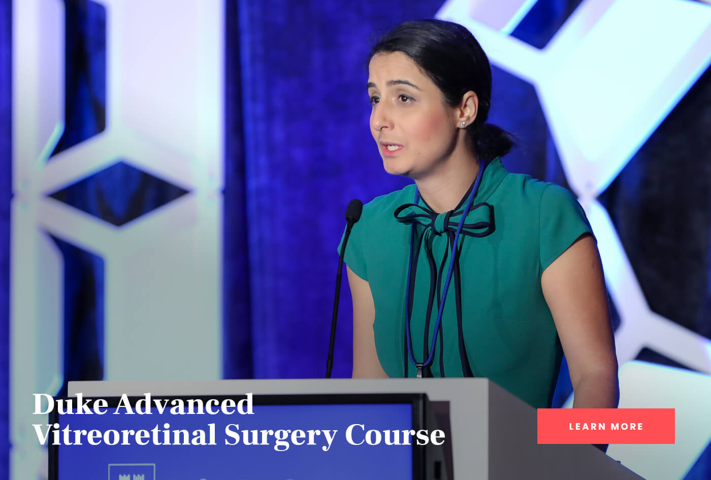 Speaker at the podium at the Duke Advanced Vitreoretinal Surgery Course