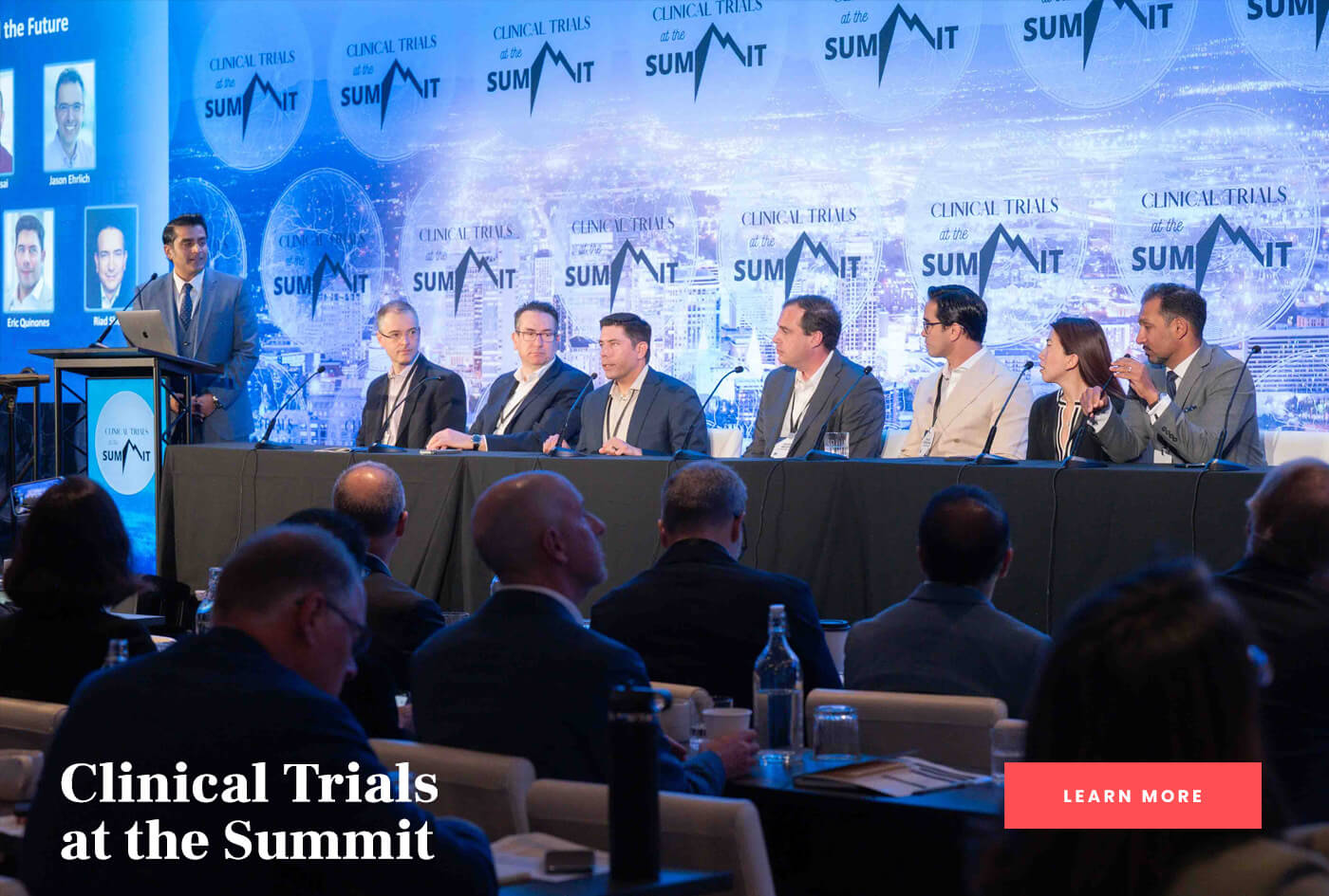 Panel at a long table for Clinical Trials at the Summit