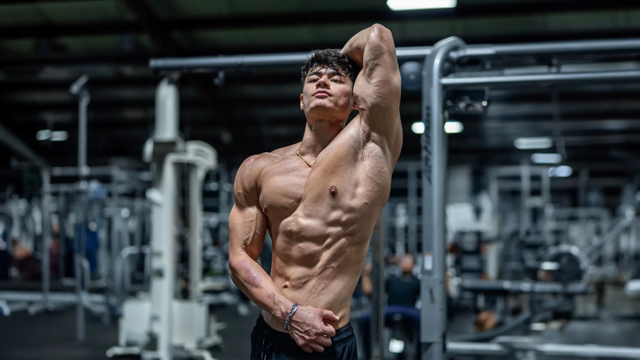 Muscular creator posing in gym