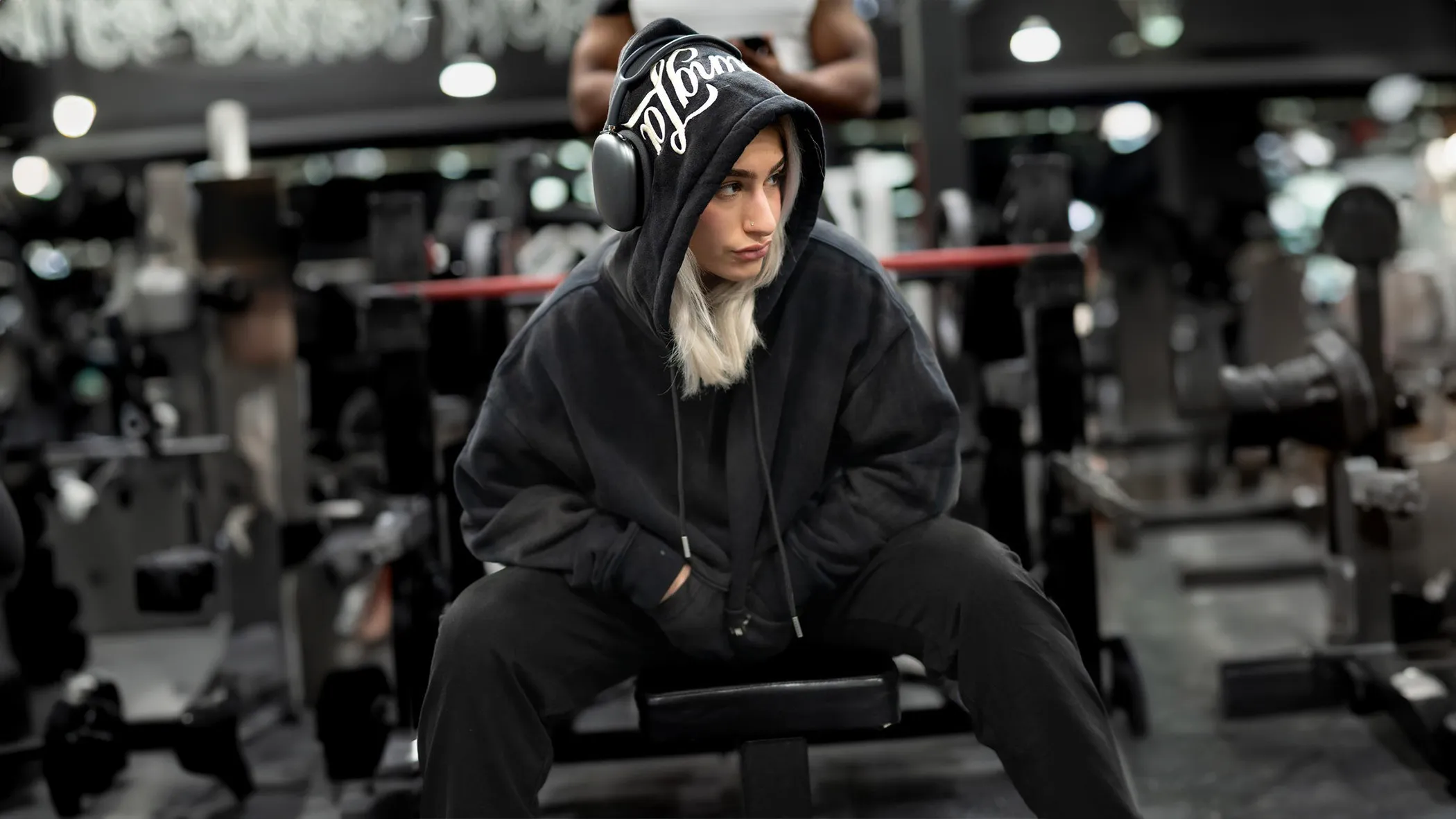 Creator with headphones on gym bench