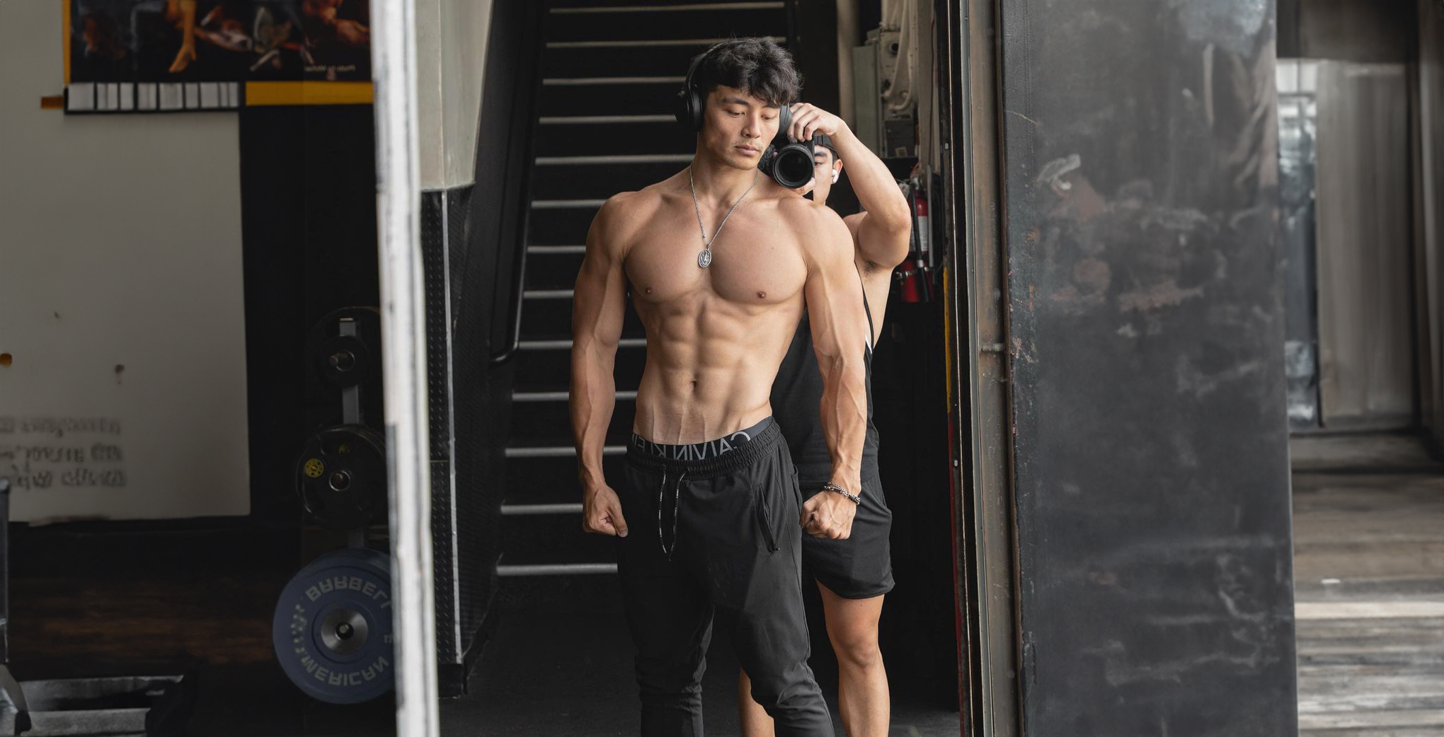 Athlete in gym doorway with headphones