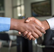 Close-up handshake between two people in business attire