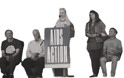 Black-and-white photo of five people posed around an AIDS Action Committee sign.
