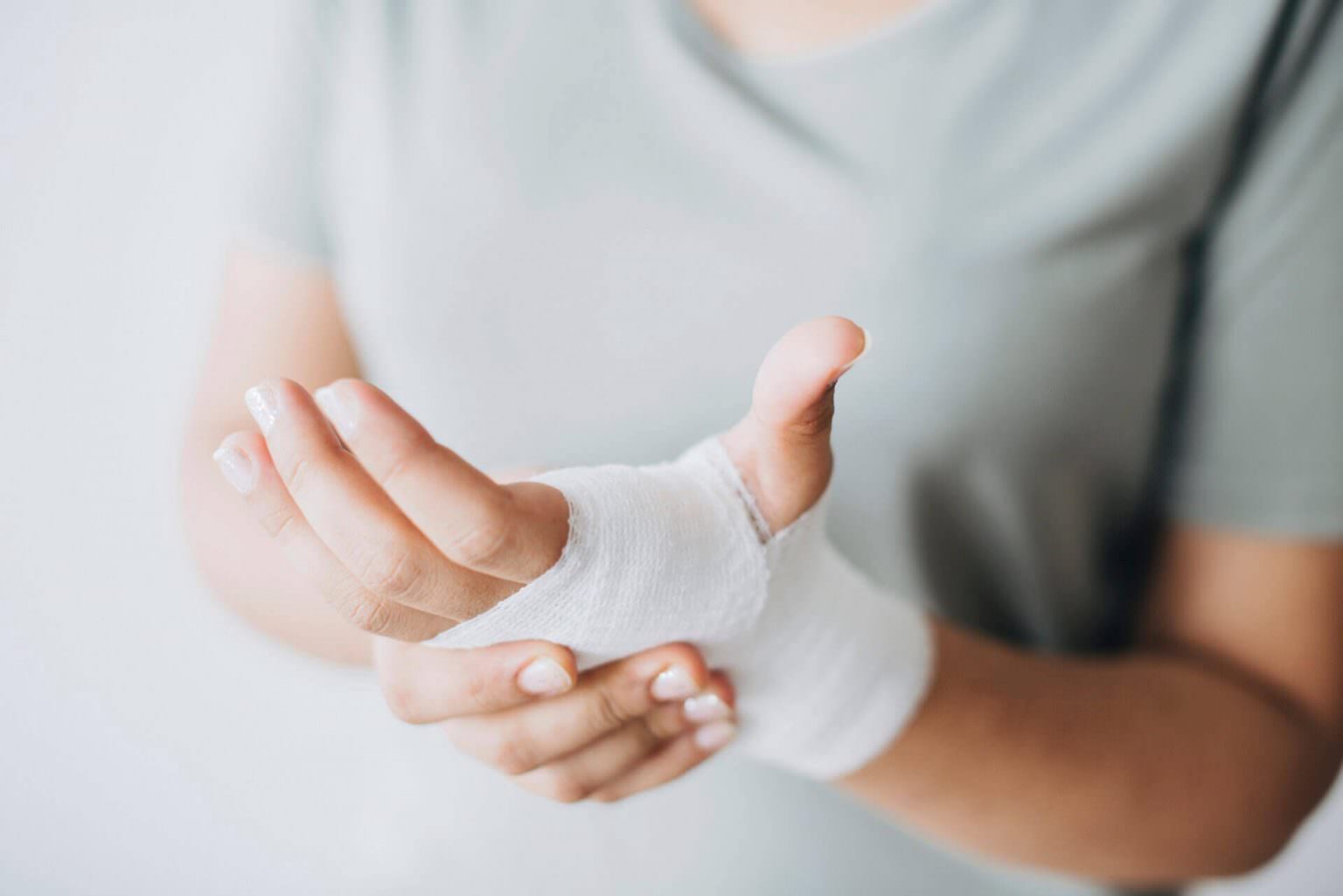 Close-up of a bandaged hand being held