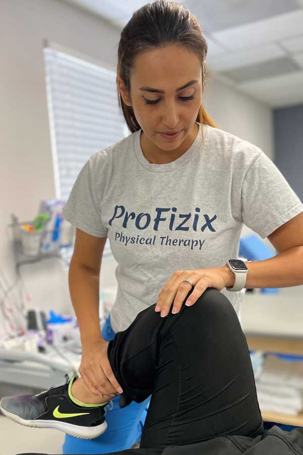 ProFizix therapist treating a patient's leg in the clinic
