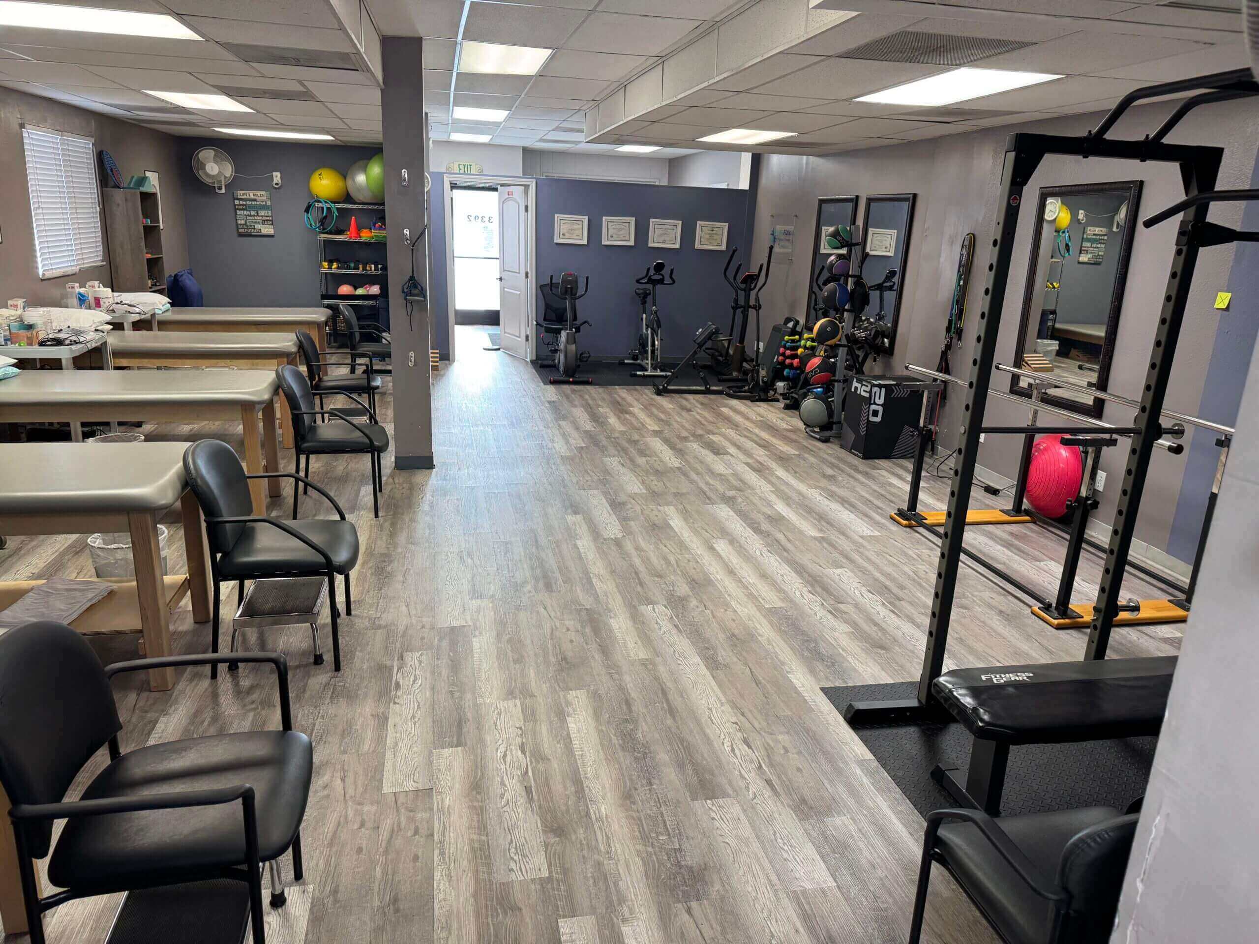 Wide view of a ProFizix clinic interior with treatment tables and exercise machines