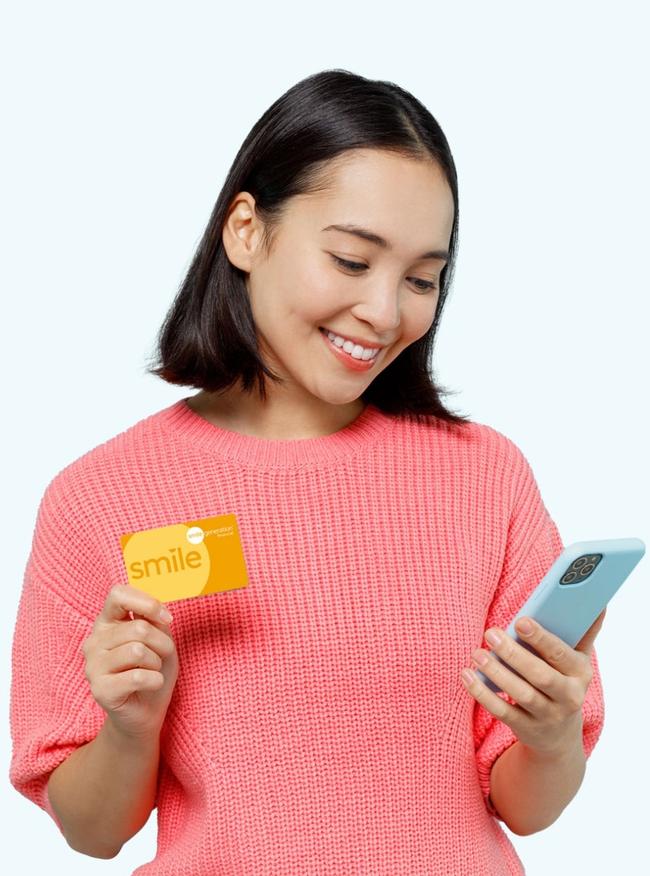 Woman holding a Smile Generation card and phone
