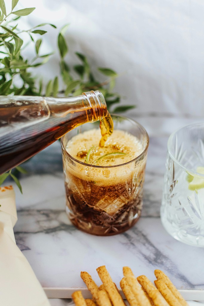 Dark beverage poured into a crystal glass