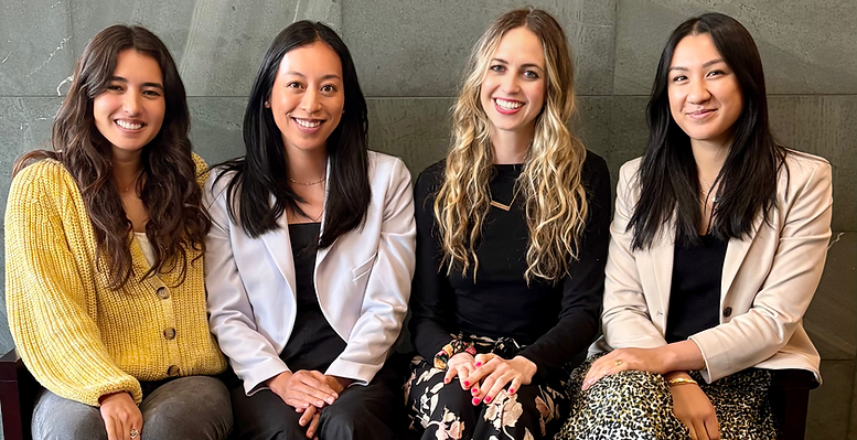 The four LK Nutrition dietitians seated together against a concrete wall