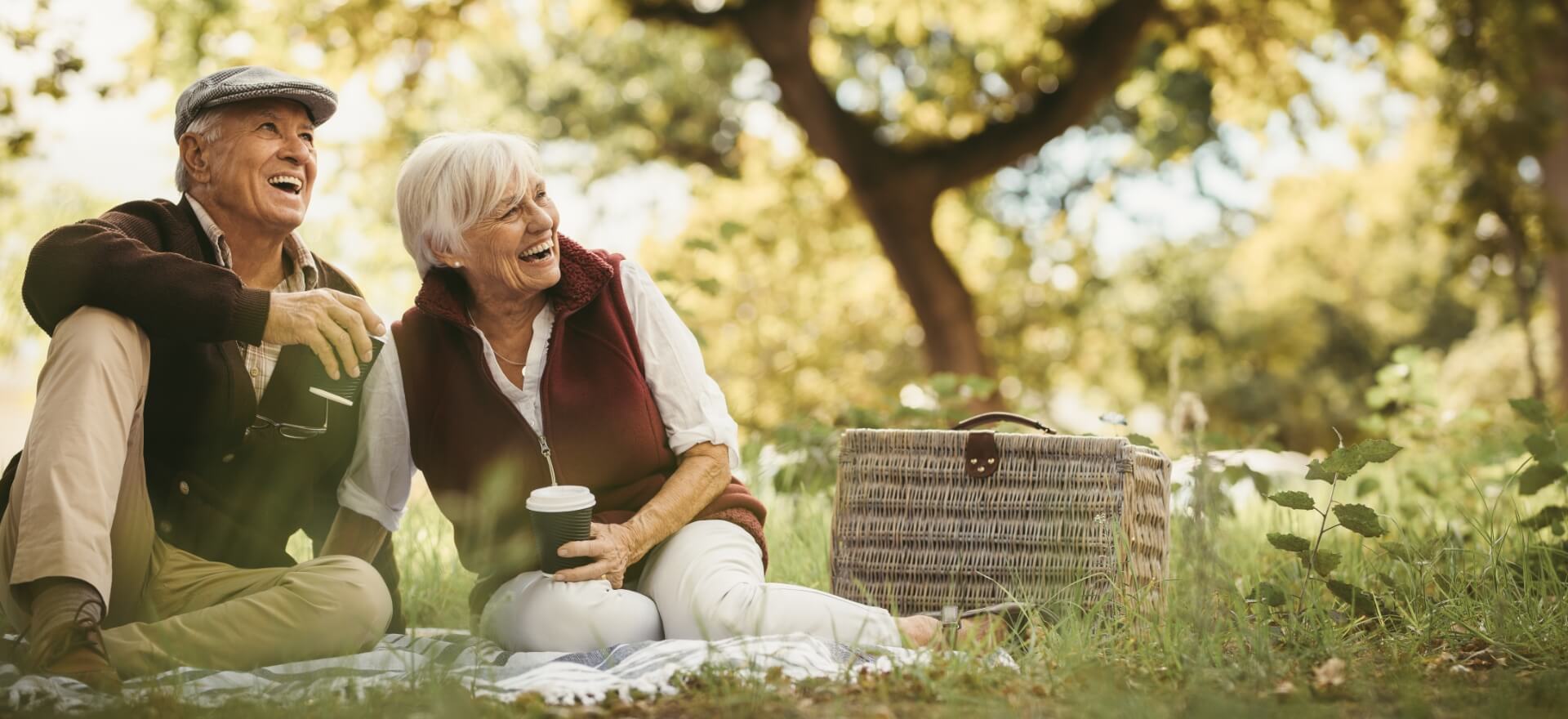 An older couple laughing together outdoors
