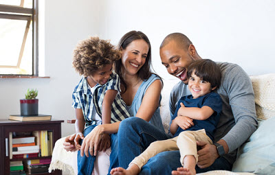 A family with a young child relaxing in the dental office
